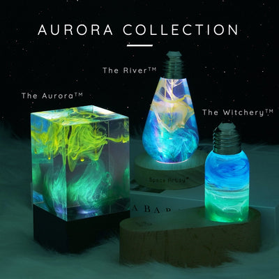 A collection of three decorative lamps from the Aurora Collection, showcasing a nebulas-like pattern in green, blue, and purple colors.