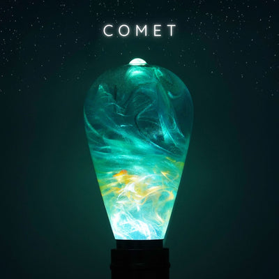 Decorative light bulb with swirling green and yellow design on a dark background with 'COMET' text.