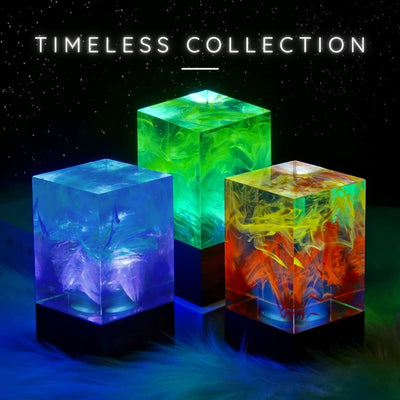 A set of three colorful resin art candle holders from the Timeless Collection, displaying a vibrant mix of blue, green, and red hues with visible patterns inside.