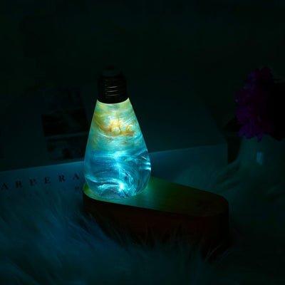 Glowing light bulb-shaped lamp on a dark background