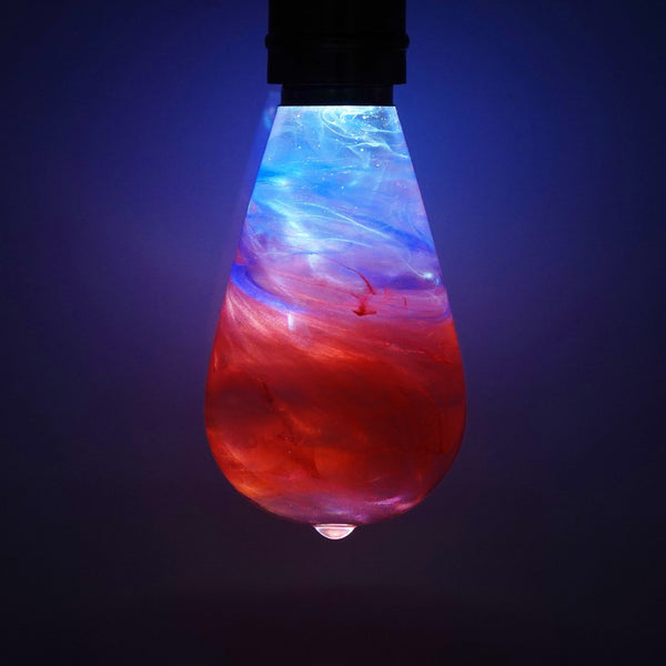 Marbled red and blue light bulb against a dark background